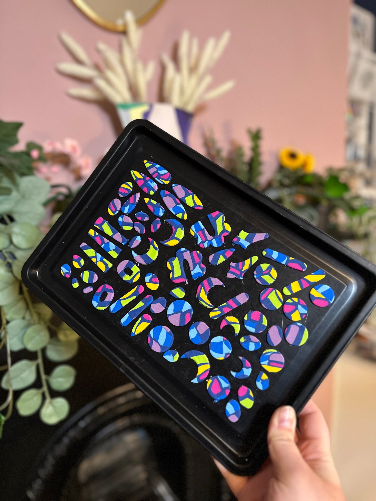 Image of a baking tray with polymer clay earring pieces on it